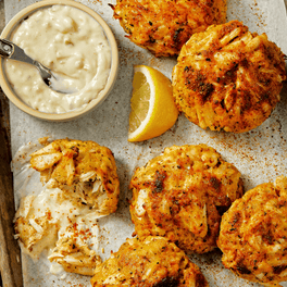 crabcakes with dipping sauce and lemon