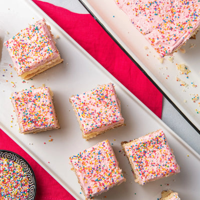 A plate of strawberry frosted cakes